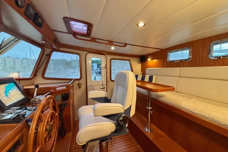 Slide: The Image of Luxurious 2009 Kadey-Krogen yacht interior with helm, seating, and navigation equipment. - 13