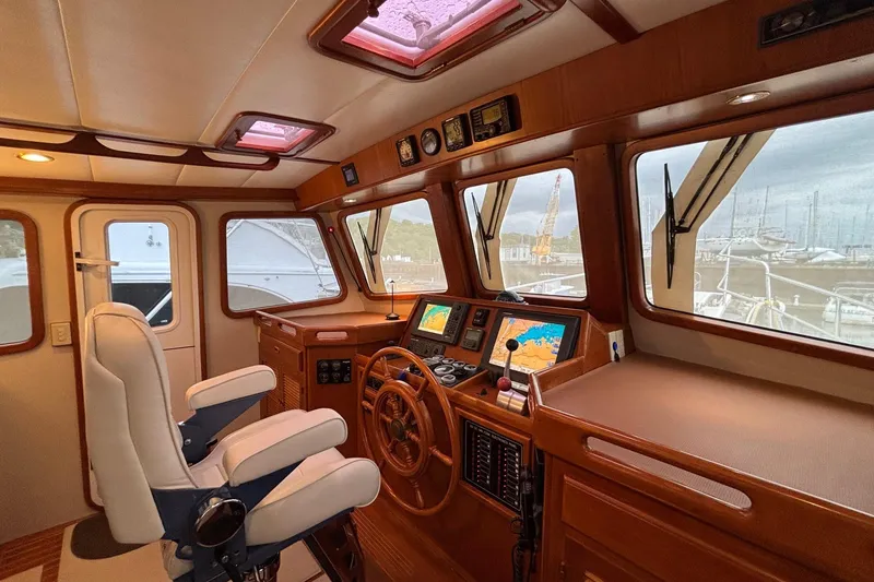 Slide: The Image of Pilothouse interior of a 2009 Kadey-Krogen yacht with navigation equipment and helm. - 14