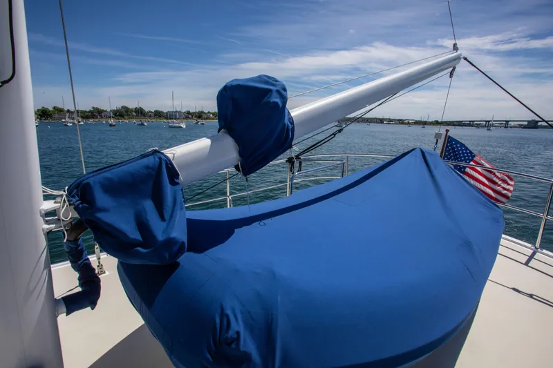 Slide: The Image of 2009 Kadey-Krogen 44 yacht with blue cover and US flag. - 20
