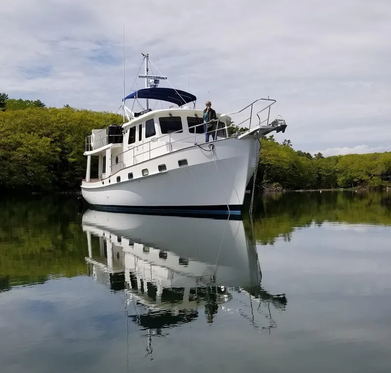 Slide: The Image of 2009 Kadey-Krogen 44 yacht anchored on calm water. - 3