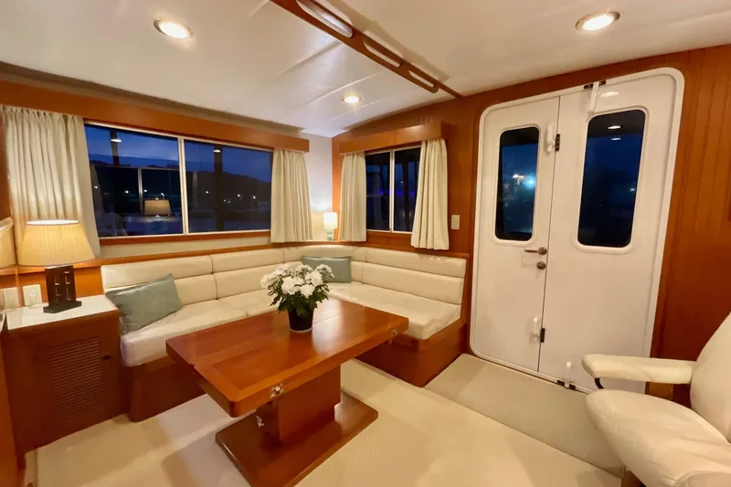 Slide: The Image of Luxurious 2009 Kadey-Krogen yacht interior with elegant seating, wooden table, and ambient lighting. - 5
