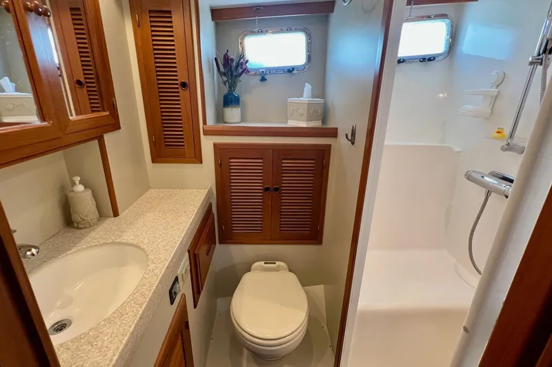 Slide: The Image of Luxurious 2009 Kadey-Krogen yacht bathroom with wooden cabinets and modern fixtures. - 9