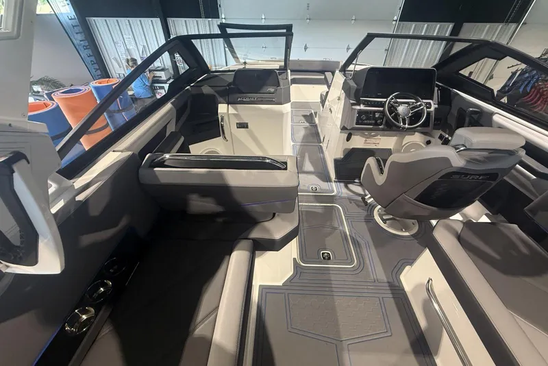 Slide: The Image of 2024 Cobalt R8 Surf boat interior with modern seating and sleek dashboard design. - 12
