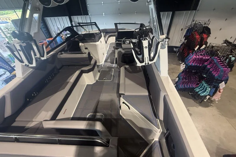 Slide: The Image of 2024 Cobalt R8 Surf boat interior with seating and steering wheel, displayed in showroom. - 14