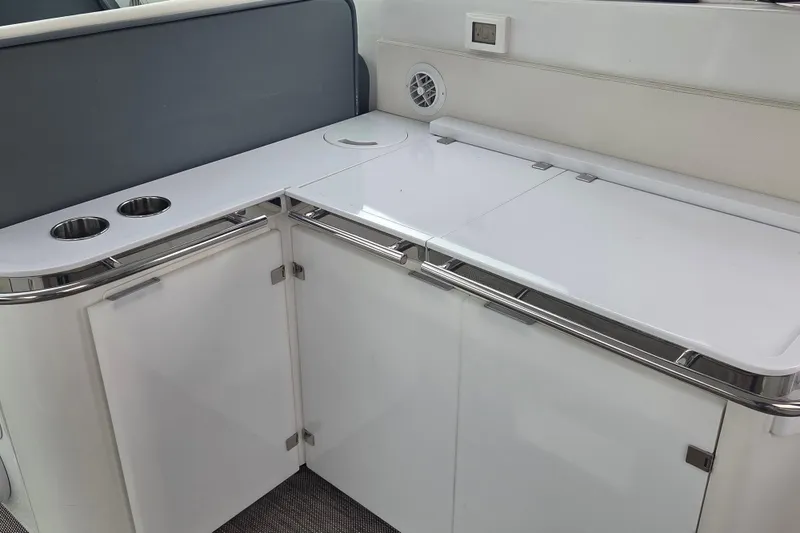 Slide: The Image of Interior of 2017 Cobalt A40 Coupe featuring sleek white cabinetry and cup holders. - 18