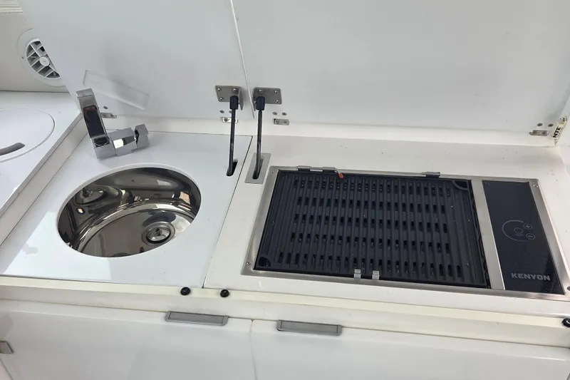 Slide: The Image of Compact kitchen area with sink and grill on 2017 Cobalt A40 Coupe. - 19