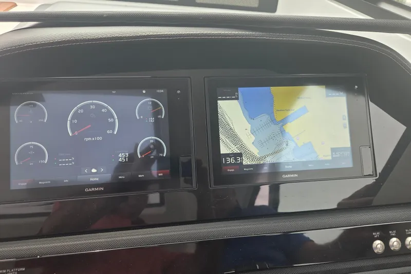 Slide: The Image of Garmin navigation and control screens on a 2017 Cobalt A40 Coupe dashboard. - 2