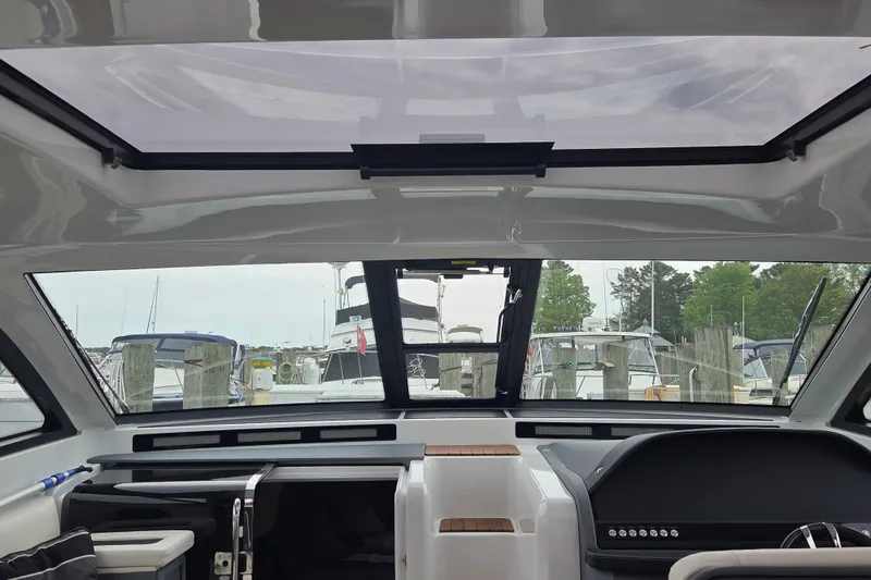 Slide: The Image of Interior view of 2017 Cobalt A40 Coupe yacht, showcasing sleek design and marina backdrop. - 23