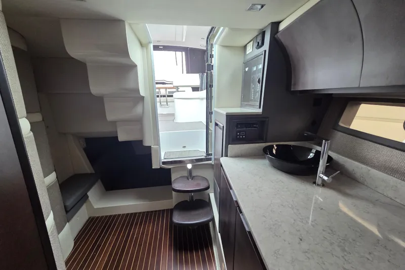 Slide: The Image of Interior of 2017 Cobalt A40 Coupe yacht with modern kitchen and seating area. - 26