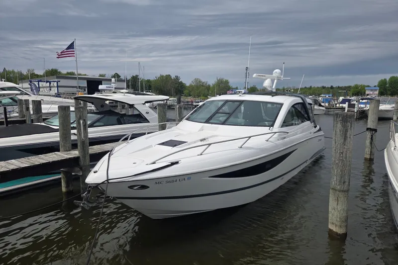 Slide: The Image of 2017 Cobalt A40 Coupe docked at marina, American flag in background. - 35