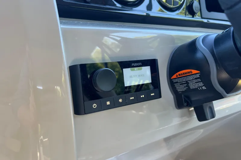 Slide: The Image of Control panel of 2026 Manitou 23 Aurora LE RF boat with Fusion audio system. - 11