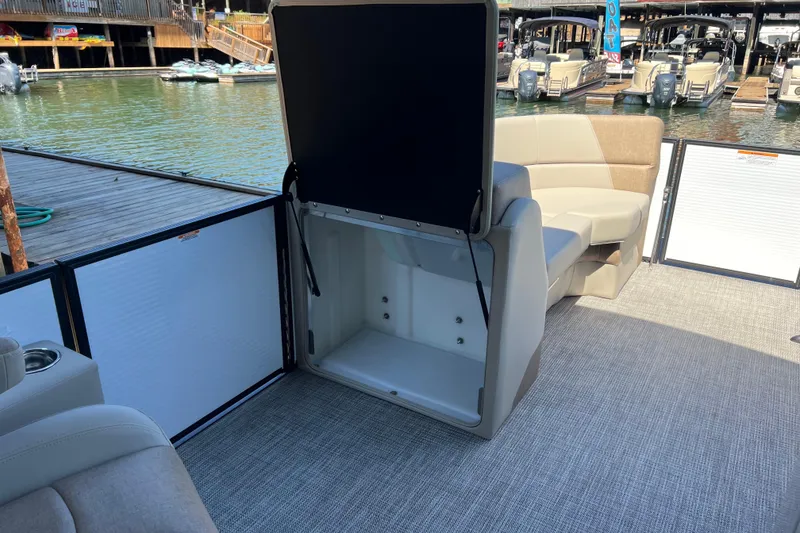 Slide: The Image of 2026 Manitou 23 Aurora LE RF pontoon boat interior with open storage compartment. - 13