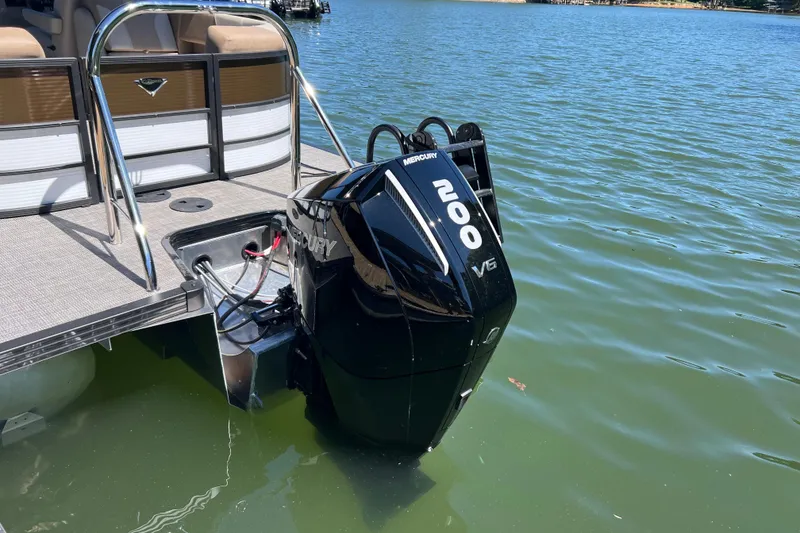 Slide: The Image of 2026 Manitou 23 Aurora LE RF with Mercury 200 V6 engine on a lake. - 3