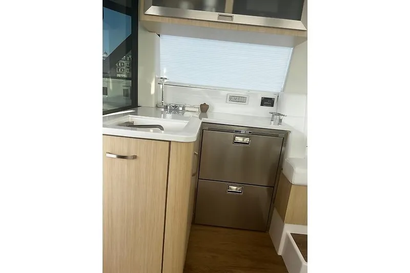 Slide: The Image of 2024 Regal 38 Grande Coupe yacht kitchen with modern cabinetry and stainless steel appliances. - 13