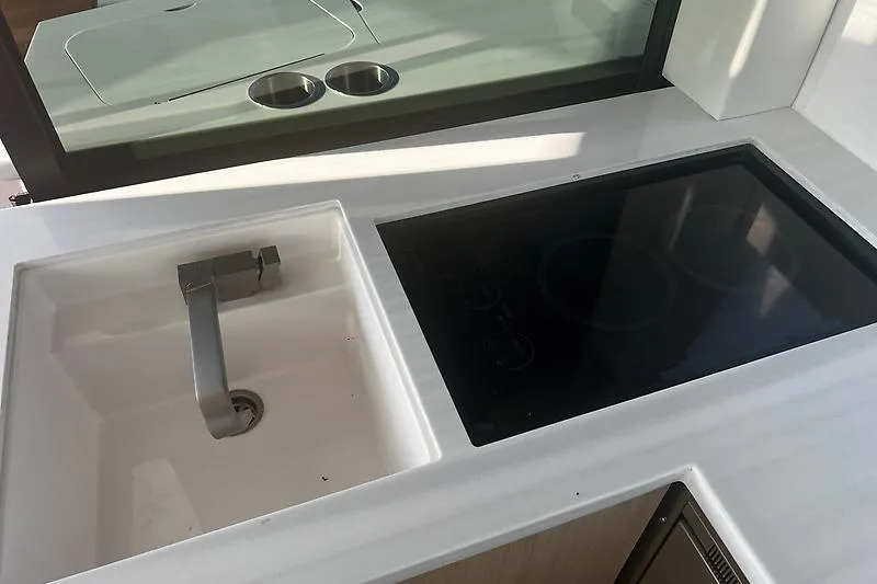 Slide: The Image of Modern kitchen area in 2024 Regal 38 Grande Coupe yacht with sink and stovetop. - 14