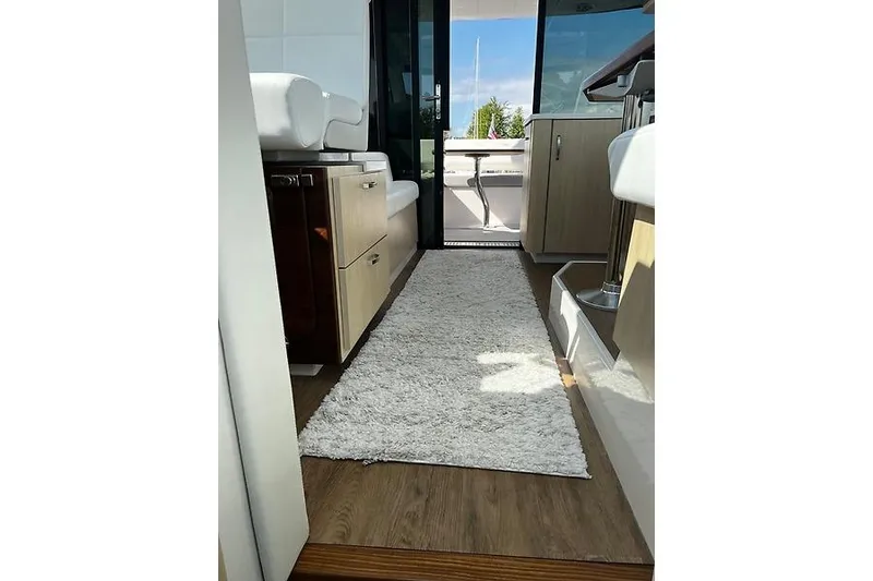 Slide: The Image of Interior view of 2024 Regal 38 Grande Coupe yacht with modern design and plush carpeting. - 15