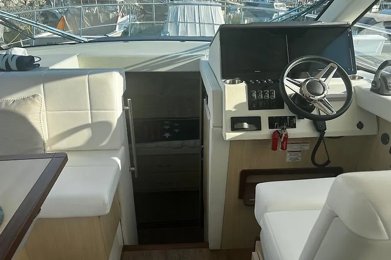 Slide: The Image of Interior cockpit of 2024 Regal 38 Grande Coupe with modern steering and controls. - 16