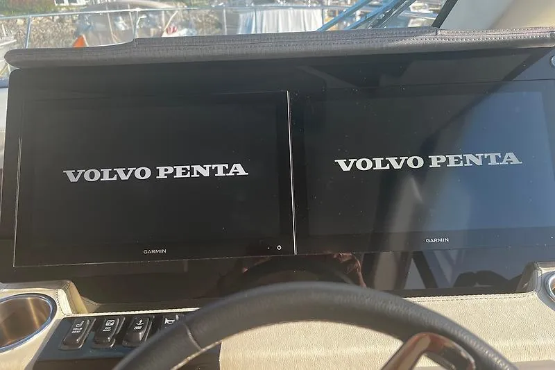 Slide: The Image of Dual Garmin displays on 2024 Regal 38 Grande Coupe dashboard showing Volvo Penta logo. - 17