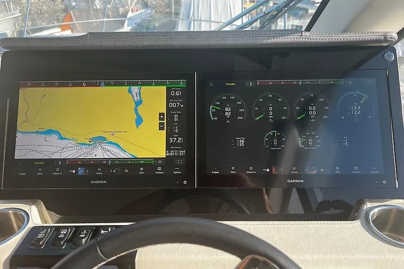 Slide: The Image of Garmin navigation and control screens on 2024 Regal 38 Grande Coupe yacht dashboard. - 18