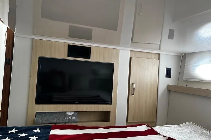 Slide: The Image of Luxurious interior of 2024 Regal 38 Grande Coupe with TV and modern cabinetry. - 22