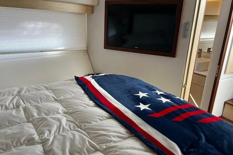 Slide: The Image of Luxurious bedroom interior of 2024 Regal 38 Grande Coupe yacht with cozy bedding. - 23