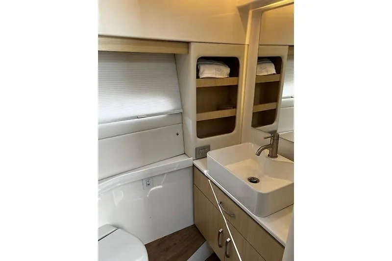 Slide: The Image of 2024 Regal 38 Grande Coupe bathroom with modern sink and storage shelves. - 26