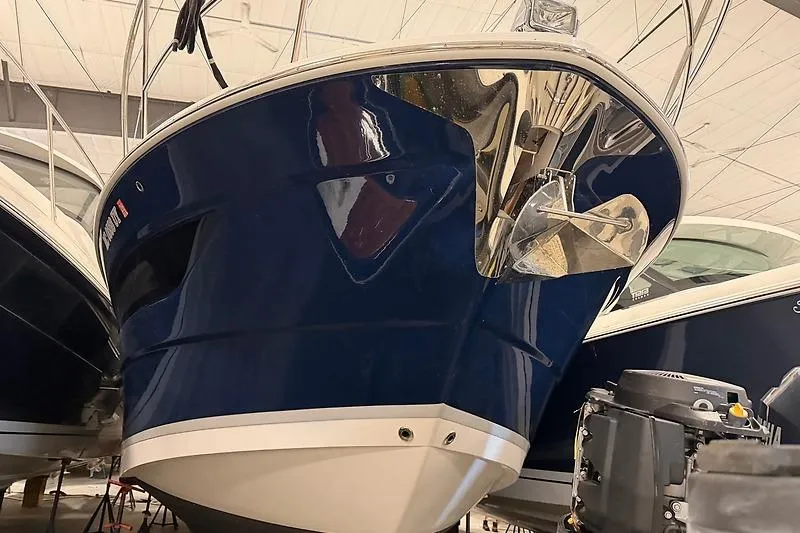 Slide: The Image of 2024 Regal 38 Grande Coupe boat in showroom, showcasing sleek blue hull design. - 27