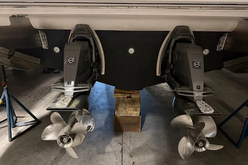 Slide: The Image of 2024 Regal 38 Grande Coupe boat propellers and drives in a maintenance setting. - 29
