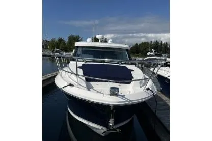 Slide: The Image of 2024 Regal 38 Grande Coupe yacht docked at marina under clear blue sky. - 3