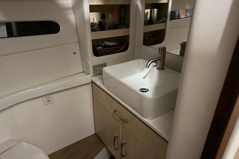 Slide: The Image of 2024 Regal 38 Grande Coupe bathroom with modern sink and storage shelves. - 31