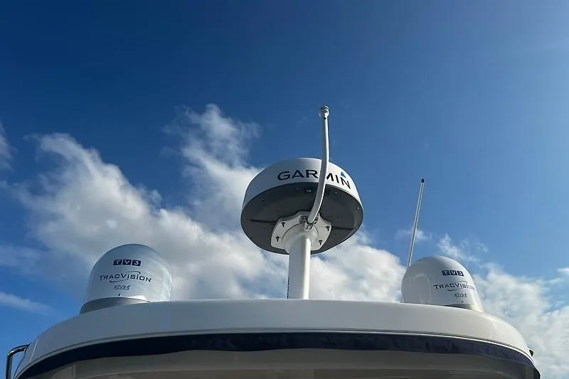 Slide: The Image of Radar and satellite equipment on 2024 Regal 38 Grande Coupe against blue sky. - 4