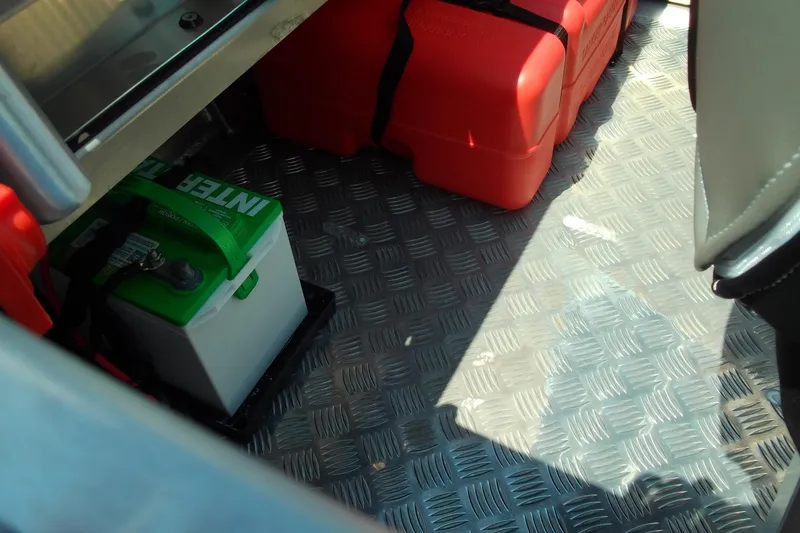Slide: The Image of Interior of 2026 Stabicraft 1450 Frontier showing battery and fuel containers. - 8