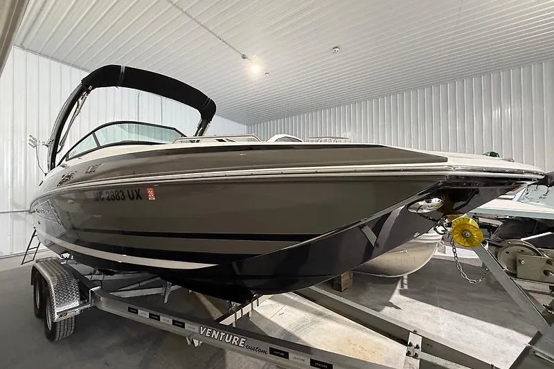 The Image of 2016 Regal 24 FasDeck RX boat on trailer in indoor storage facility. - 0