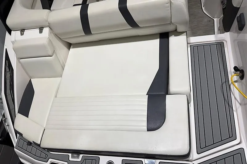 Slide: The Image of 2016 Regal 24 FasDeck RX boat interior with white and black seating. - 11