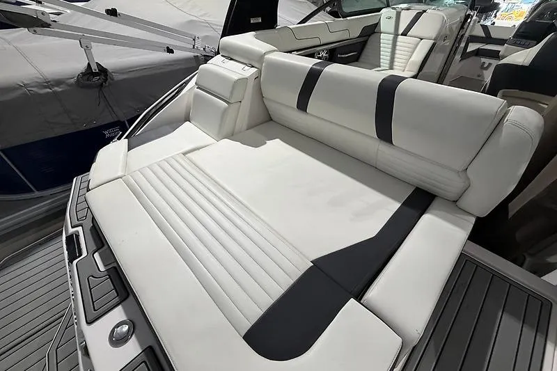Slide: The Image of 2016 Regal 24 FasDeck RX boat with white and black seating, showcasing luxury interior design. - 12