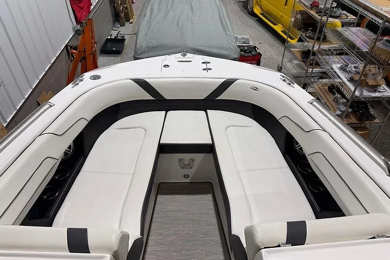 Slide: The Image of 2016 Regal 24 FasDeck RX boat interior with white seating in a storage area. - 13