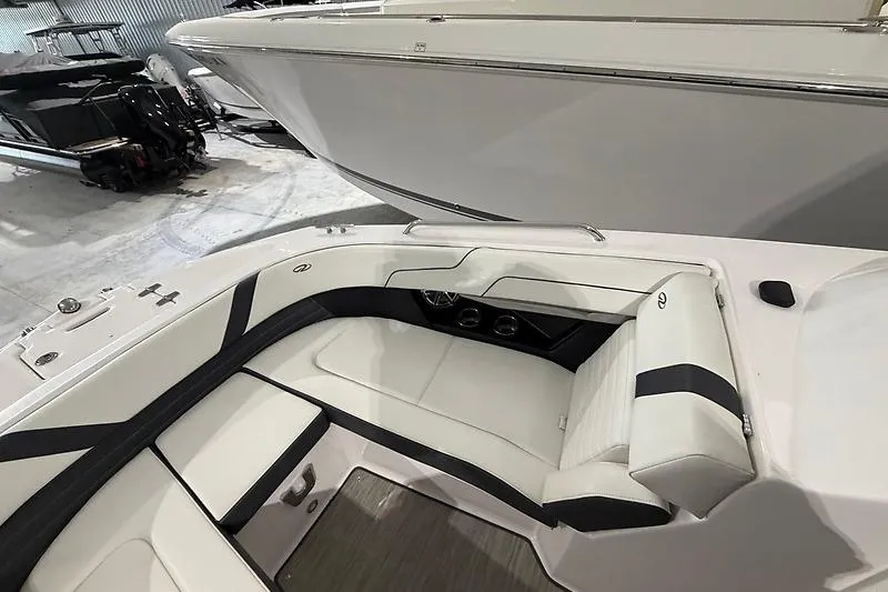 Slide: The Image of 2016 Regal 24 FasDeck RX boat interior with white and black seating. - 16