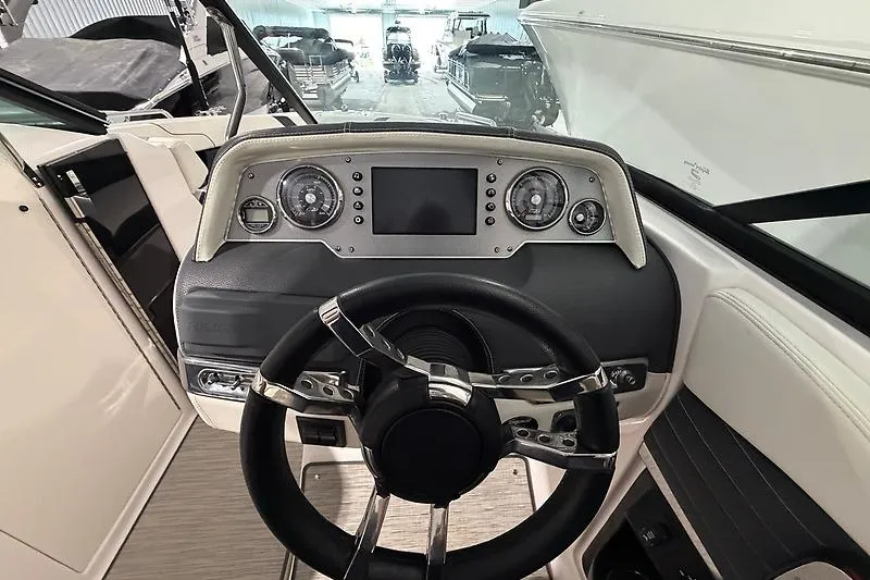 Slide: The Image of Cockpit view of 2016 Regal 24 FasDeck RX boat with steering wheel and dashboard. - 19