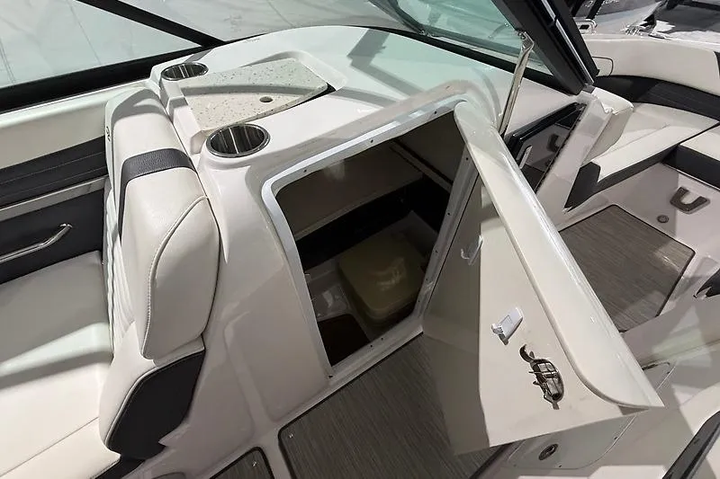 Slide: The Image of 2016 Regal 24 FasDeck RX boat interior with open storage compartment and cup holders. - 23