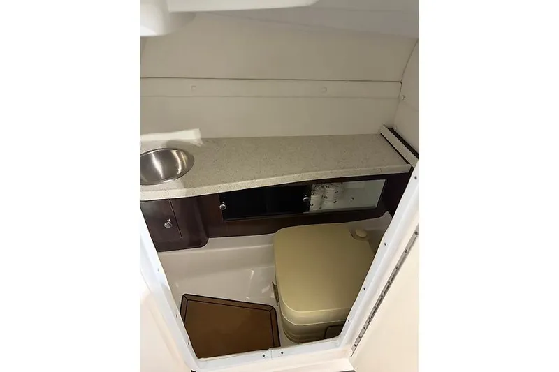 Slide: The Image of 2016 Regal 24 FasDeck RX boat interior with sink and storage area. - 25