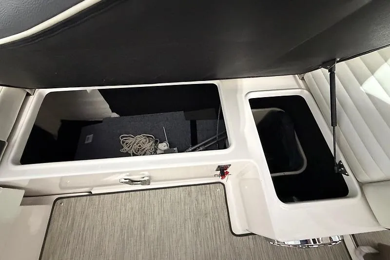 Slide: The Image of Open storage compartments on a 2016 Regal 24 FasDeck RX boat interior. - 39