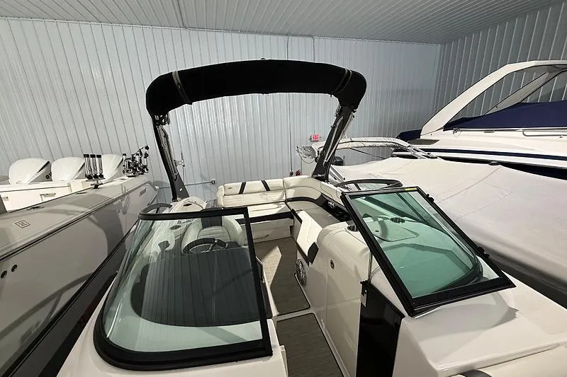 Slide: The Image of 2016 Regal 24 FasDeck RX boat in storage, featuring sleek design and spacious seating. - 8