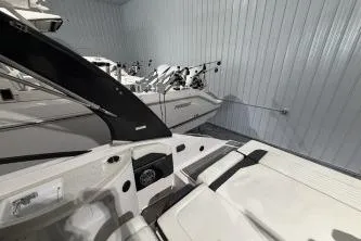 Slide: The Image of 2016 Regal 24 FasDeck RX boat in storage, showcasing sleek design and modern features. - 9