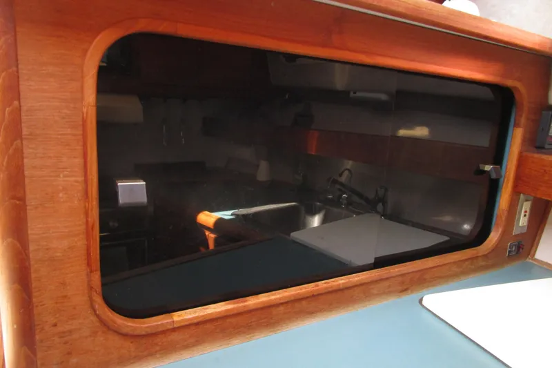 Slide: The Image of 1989 Bayliner 3288 Motoryacht interior with wooden cabinetry and kitchen sink. - 10