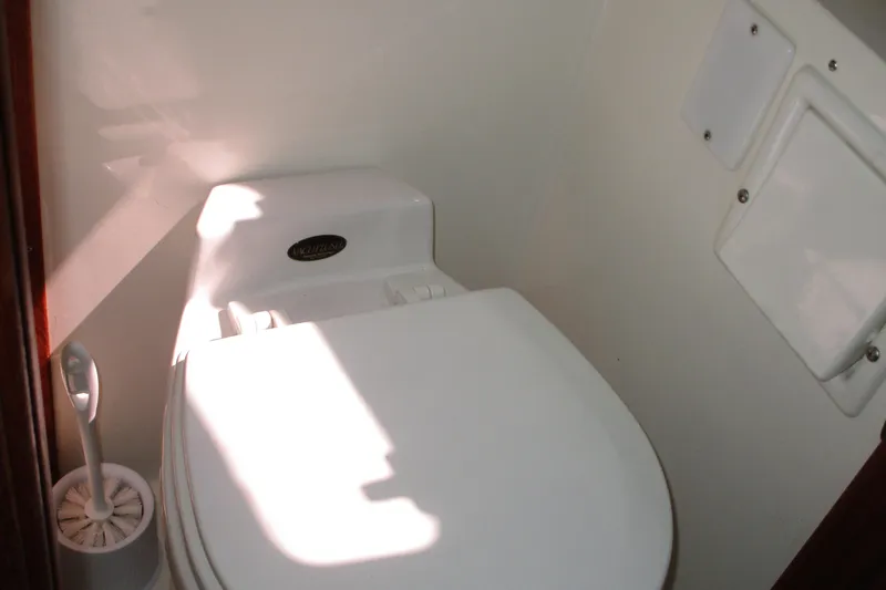 Slide: The Image of Toilet area in 1989 Bayliner 3288 Motoryacht, featuring a compact design. - 12