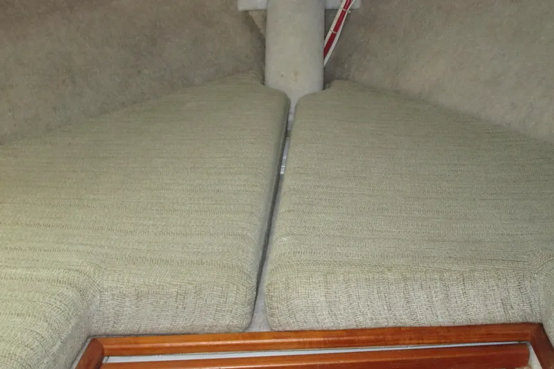 Slide: The Image of Interior cabin view of 1989 Bayliner 3288 Motoryacht with beige cushions. - 13