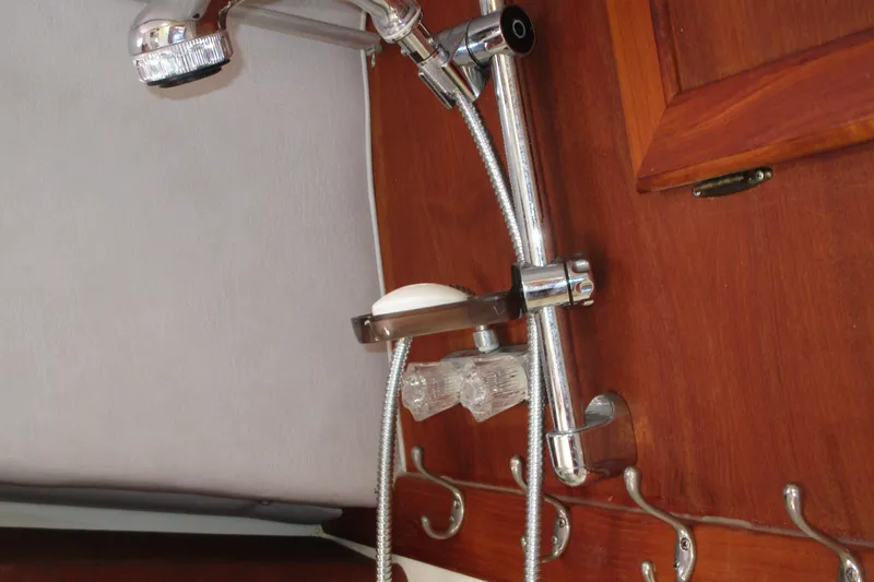 Slide: The Image of Shower fixture in 1989 Bayliner 3288 Motoryacht bathroom with wooden paneling. - 15