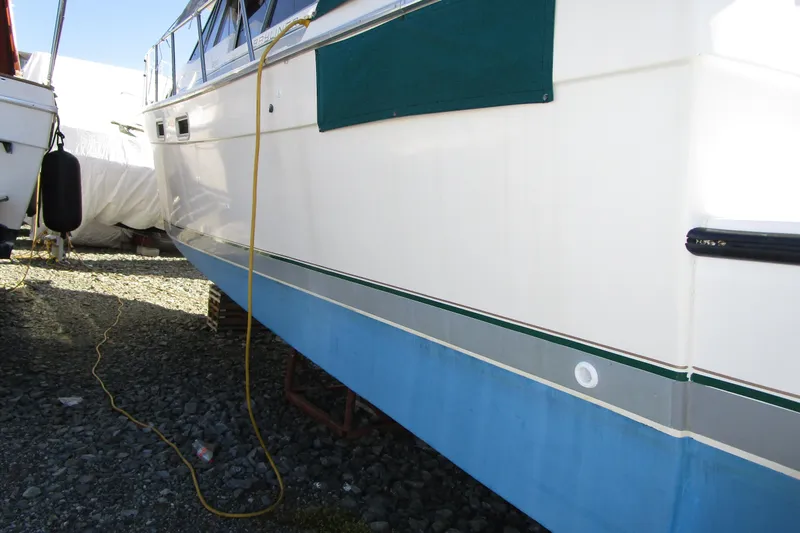 Slide: The Image of 1989 Bayliner 3288 Motoryacht on dry dock, showcasing hull and exterior details. - 2