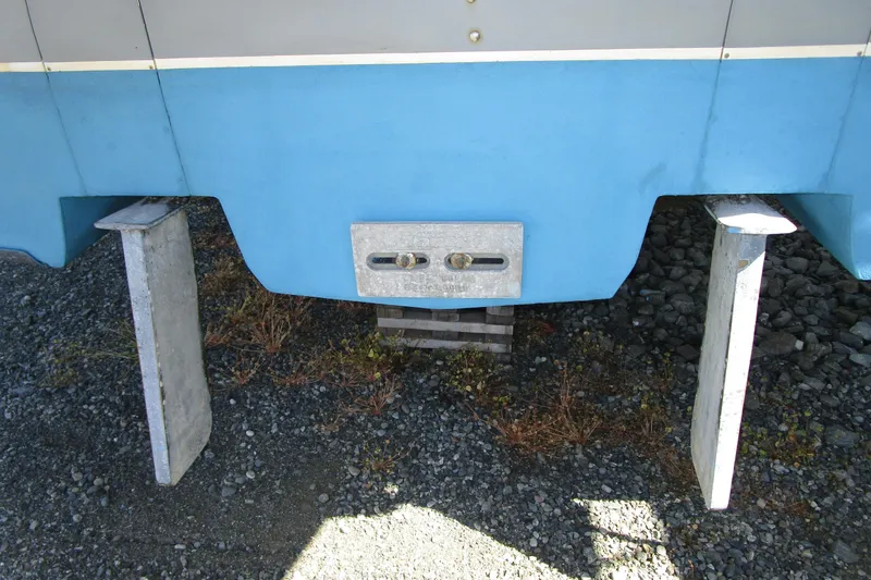 Slide: The Image of 1989 Bayliner 3288 Motoryacht hull on stands, showing blue and gray exterior. - 6