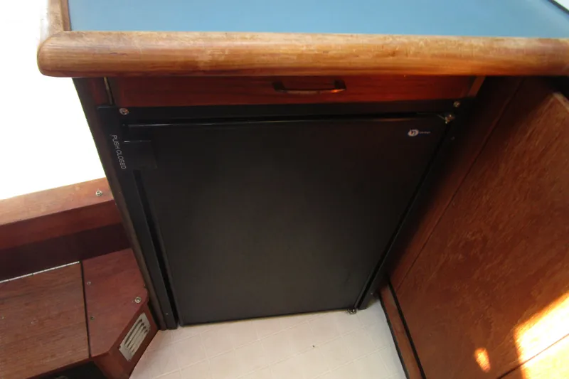 Slide: The Image of 1989 Bayliner 3288 Motoryacht interior with compact black refrigerator. - 9